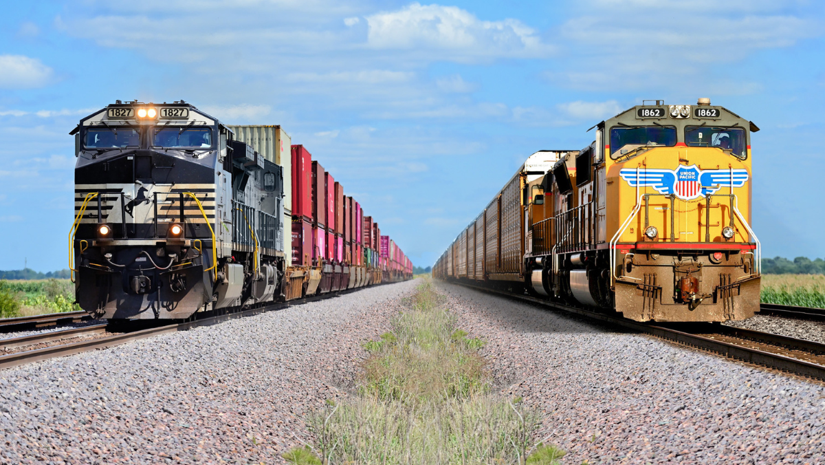Freight trains from Union Pacific and Norfolk Southern facing each other on parallel tracks.