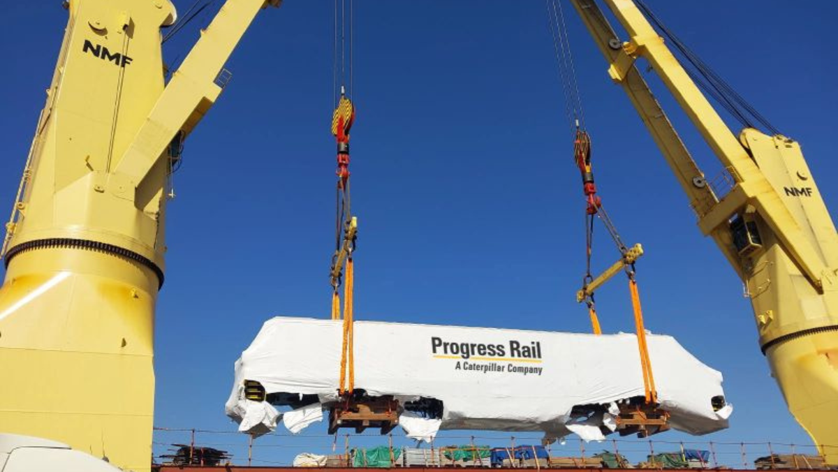 Progress Rail locomotive lifted by cranes during rail maintenance operation